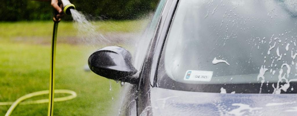 auto wird mit wasserschlauch gereinigt 